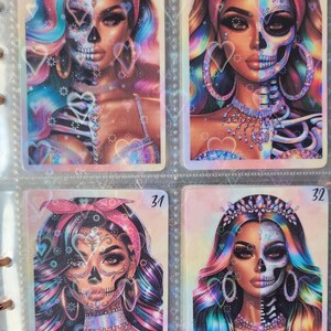 May include: Four colorful cards with images of women with half of their face as a skull and half as a human. The cards are numbered 21, 30, 31, and 32.