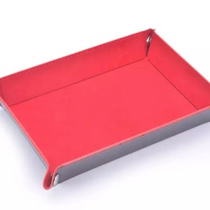 May include: A red felt-lined dice tray with a black leather exterior. The tray has four silver metal corners.