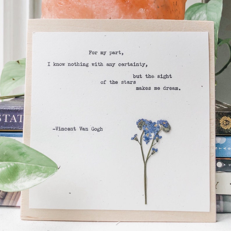 May include: A wooden sign with a quote by Vincent Van Gogh: "For my part, I know nothing with any certainty, but the sight of the stars makes me dream."