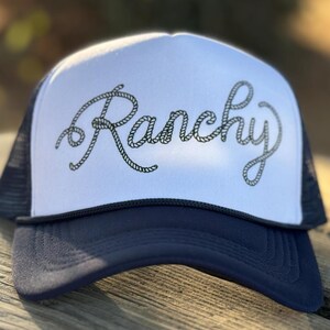 Trucker hat, RANCHY, trendy hat, cowgirl, western, dark blue with art on foam front panel.  Mesh back with adjustable snap.