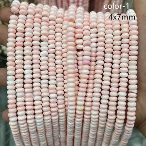 May include: Strands of pink and white beads, each measuring 4x7mm, are displayed. The beads have a smooth, rounded shape and are strung together, creating a textured surface. The image includes the text "color-1" and "4x7mm".