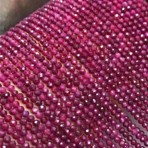 May include: A strand of ruby red gemstone beads, each bead is faceted and measures approximately 2mm in diameter. The beads are strung on a thin thread and are ready for jewelry making.
