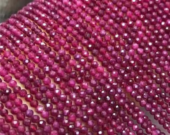 May include: A strand of ruby red gemstone beads, each bead is faceted and measures approximately 2mm in diameter. The beads are strung on a thin thread and are ready for jewellery making.