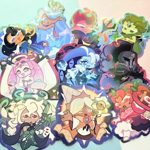 May include: A collection of holographic stickers featuring various stylized cartoon characters with diverse hair colors, outfits, and accessories, including swords, staffs, and musical instruments, rendered in a vibrant, colorful, and glossy finish.