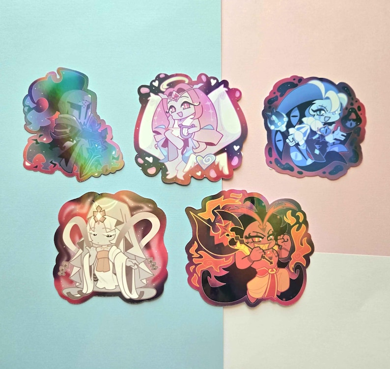 May include: Five die-cut stickers featuring stylized anime-inspired characters. The top left is a holographic knight, the top center is a pink-haired figure with wings, the top right is a blue-toned character, the bottom left is a white-robed figure, and the bottom right is a fiery character.
