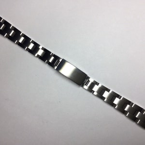 May include: A silver watch band with a brushed finish and a polished centre link.