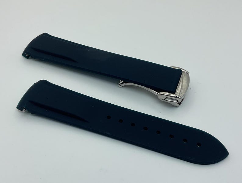 May include: Two black silicone watch straps with silver buckles. The straps are designed for a watch with a 22mm lug width.