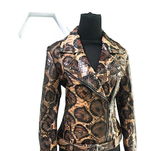 May include: A brown and black snakeskin leather jacket with a zipper closure and a belt.