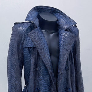 May include: A long blue snakeskin trench coat with a double breasted closure and a belt.