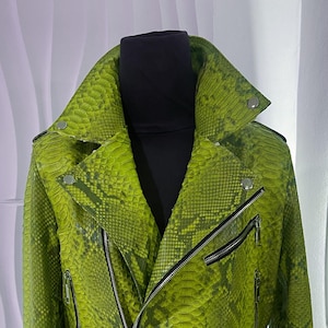May include: A green snakeskin leather jacket with a zipper closure and multiple pockets.