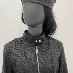 May include: Black leather jacket with a zipper closure and a snakeskin pattern.