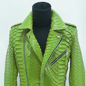 May include: A green snakeskin leather jacket with a zipper closure and a belt. The jacket has a textured surface and a  distinctive pattern.