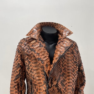 May include: A brown and black snakeskin leather jacket with a zipper closure.