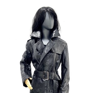 May include: A black snakeskin trench coat with a double-breasted closure, a belt, and a collar.