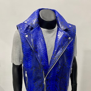 May include: A blue snakeskin leather waistcoat with a zip fastening and a belt. The waistcoat has a biker style and is made of genuine leather.