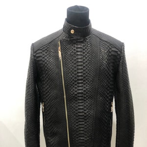 May include: A black leather jacket with a snakeskin pattern and gold zippers.