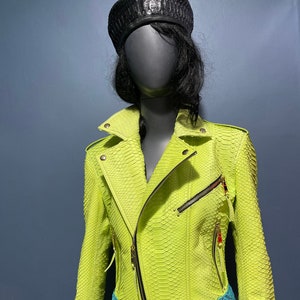 May include: A bright neon green leather jacket with a zipper closure and a blue belt. The jacket is made of snakeskin.