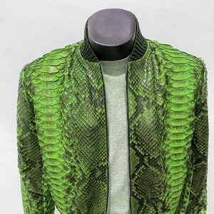 May include: A green snakeskin bomber jacket with a black zipper and ribbed cuffs and waistband.
