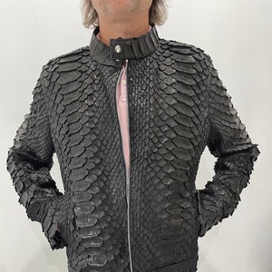 May include: A black leather jacket with a zipper closure and a snakeskin pattern.