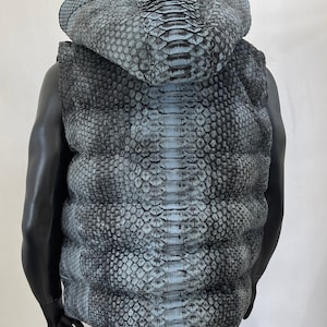 May include: A sleeveless hooded vest made of blue and black snakeskin.