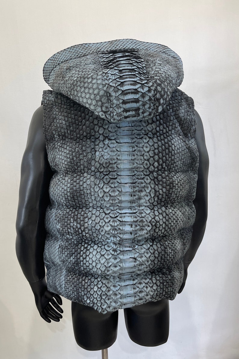 May include: A sleeveless hooded vest made of blue and black snakeskin.