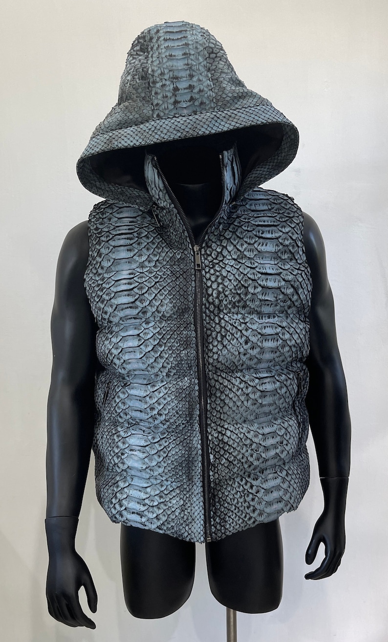 May include: A hooded vest made of blue snakeskin with a zipper closure.