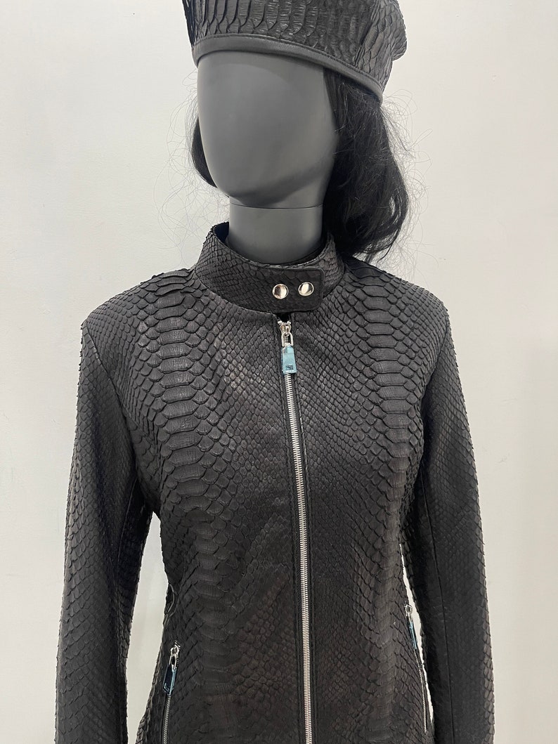 May include: Black leather jacket with a zip fastening and a snakeskin pattern.