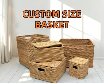 May include: Several woven rattan baskets of varying sizes are displayed. Some have lids, and others have handles. The text "CUSTOM SIZE BASKET" is displayed in orange letters above the baskets. The baskets are a natural tan color.