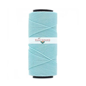 May include: A spool of light blue cotton thread, wrapped in a spiral pattern. The spool is labeled "RUMI SUMAQ".