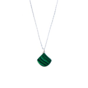 Sterling silver malachite pendant and earring set featuring a delicate triangle stone, handcrafted by Rumi Sumaq on Martha’s Vineyard. The striking malachite gemstone is known for its protective and healing properties, making this artisan jewelry set a meaningful and stylish gift. The adjustable necklace length (16, 18, or 20 inches) allows for customization, while the matching earrings add a touch of sophistication to any outfit. Malachite Jewelry Set | Malachite Earrings | Malachite Necklace
