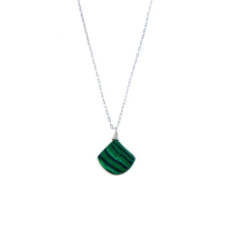 Sterling silver malachite pendant and earring set featuring a delicate triangle stone, handcrafted by Rumi Sumaq on Martha’s Vineyard. The striking malachite gemstone is known for its protective and healing properties, making this artisan jewelry set a meaningful and stylish gift. The adjustable necklace length (16, 18, or 20 inches) allows for customization, while the matching earrings add a touch of sophistication to any outfit. Malachite Jewelry Set | Malachite Earrings | Malachite Necklace