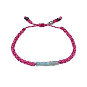 Handmade pink Peruvian Opal bracelet by Rumi Sumaq, intricately hand-knotted by Indigenous Quechua artist Coco in his Martha’s Vineyard studio. The bracelet features seven genuine Peruvian Opal stones, Hematite bead accents, and a silver-toned Rumi Sumaq logo bead. Its soft pink waterproof fiber adds a feminine touch, balancing elegance and everyday wearability. Adjustable and unisex, it’s perfect for birthdays, anniversaries, or meaningful October gifts.