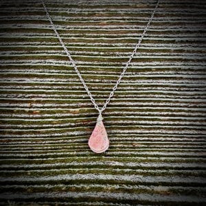 Minimalist teardrop Rhodonite pendant necklace in sterling silver, featuring a soft pink natural stone with subtle black veining. Handcrafted by Quechua jewelry designer Coco Paniora Salinas on Martha’s Vineyard in the RumiSumaq art jewelry studio. Perfect for everyday wear or layering, this versatile, modern necklace offers understated elegance, meaningful artisan-made design, gentle energy, and the signature style of Rumi Sumaq. It makes a beautiful Mother's Day gift or Valentine's Day present