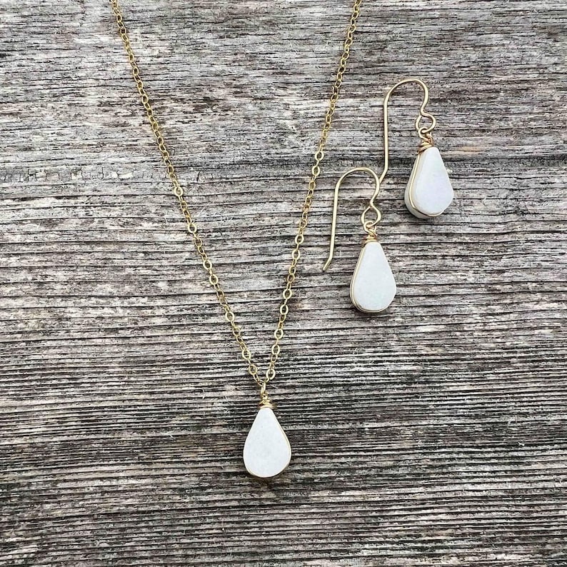 White Jasper Jewelry - This white jasper jewelry set features a teardrop pendant necklace and earrings handcrafted by Quechua artisan Coco Paniora Salinas in his Marthas Vineyard studio Rumi Sumaq. White jasper is known for its healing and protective qualities making this energy healing gift a perfect choice for those seeking balance. Available in 14k gold fill or sterling silver this gem handmade jewelry is both elegant and meaningful. The set comes packaged in beautiful RumiSumaq gift boxes.
