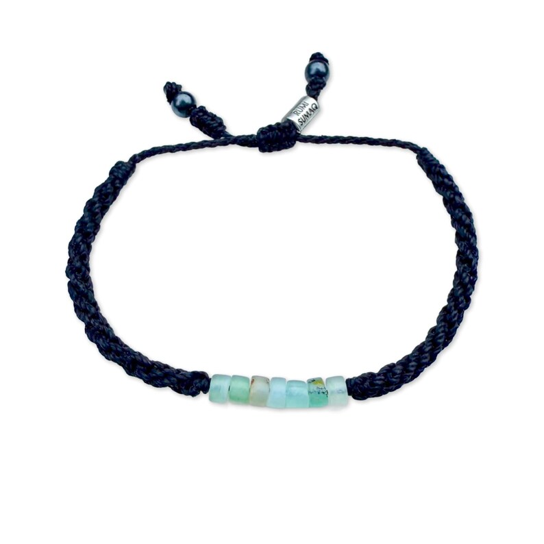 Handmade Rumi Sumaq Peruvian Opal rope bracelet in black cord with seven genuine Peruvian Opal stones, Hematite accents, and silver tone logo bead. Custom hand-knotted by Quechua designer Coco on Martha’s Vineyard, this adjustable bracelet fits men, women, and kids. Perfect personalized October birthstone or 24th anniversary gift jewelry.