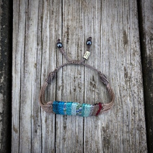 Colorful festival bracelet with a handwoven macrame design, perfect for boho lovers. This wide women’s bracelet features vibrant stripes and intricate knotting, making it a standout bohemian jewelry piece. A great hippie jewelry accessory or teenage girl gift, it’s comfortable for all-day wear. The knotted striped bracelet is a stylish boho gift for women or a bohemian gift for teens. Handmade by Rumi Sumaq, artisan macrame jewelry, woven statement bracelet.