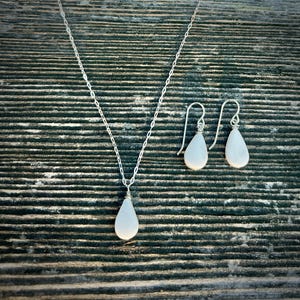 Handmade White Jasper Necklace & Earrings Set This handmade white jasper necklace & earrings set is crafted by Quechua jewelry designer Coco Paniora Salinas in his Rumi Sumaq art jewelry studio on Marthas Vineyard. The healing crystal jewelry set features a teardrop white jasper pendant necklace and matching white stone teardrop earrings available in sterling silver or 14k gold fill. White jasper is a spiritual stone known for clarity, peace and emotional healing making it a unique gift for her.