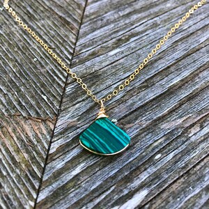 Green gemstone triangle pendant and earring set, handmade by Rumi Sumaq, featuring natural malachite stones on a delicate gold-filled or sterling silver chain. A sophisticated yet minimalist jewelry set, ideal for layering or wearing solo. This malachite necklace and earring set makes a beautiful gift for Christmas, Valentine’s Day, or Mother’s Day, offering both style and spiritual significance. Malachite Jewelry Set | Malachite Earrings | Malachite Necklace | Bday Gift for Her
