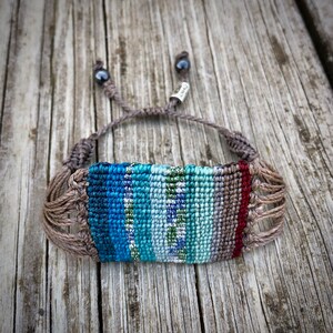 Striped boho bracelet, handwoven in colorful macrame for a bold statement. This wide women’s bracelet is perfect as hippie jewelry or a unique festival accessory. The intricate knotting makes it a standout piece of macrame jewelry for teen girls and women alike. A thoughtful teenage girl gift or bohemian gift for teens. Boho bracelet woven with durable threads for a lasting handmade touch. Rumi Sumaq artisan jewelry, women’s woven jewelry, boho gift for women.