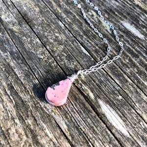 Tiny pink necklace with Rhodonite stone in teardrop shape suspends from dainty Sterling silver chain. Jewelry gift for mom from son handmade by Rumi Sumaq Jewelry.