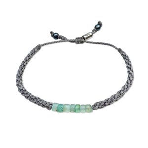 Custom handmade rope bracelet by Rumi Sumaq displayed on a white studio background featuring a line of genuine blue green Peruvian Opal stones centered between tightly knotted fiber cords in your choice of fiber color. The adjustable drawstring is finished with Hematite stone accents and a Rumi Sumaq logo bead. Rumi Sumaq jewelry is handcrafted by Quechua designer Coco Paniora Salinas on Martha’s Vineyard, the bracelet blends Peruvian artistry with coastal craftsmanship for men, women and kids.