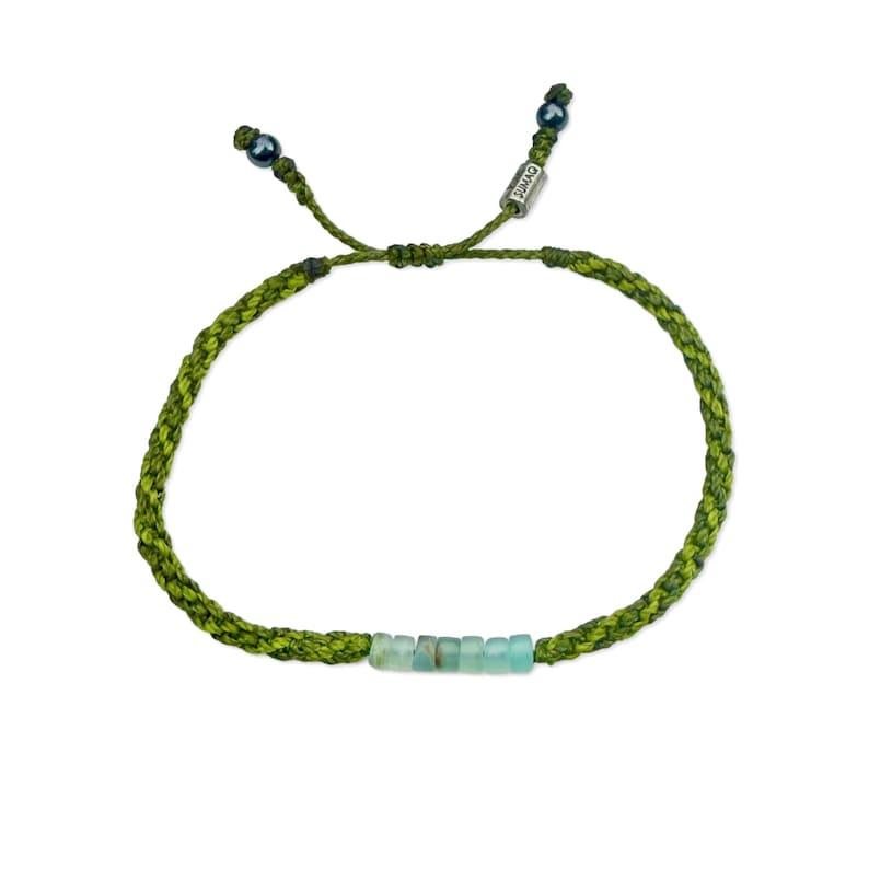 Hand-knotted Andean Opal bracelet in two-tone green fibers crafted by Indigenous Quechua artist Coco of Rumi Sumaq on Marthas Vineyard. This custom Andean Opal stone bracelet features seven genuine Peruvian Andean Opals accented with Hematite beads and a silver-toned logo bead. The calming green hues and natural opal energy promote balance, peace and creativity, making it an ideal handmade gift for men, women or kids celebrating October birthdays or anniversaries. Authentic Andean Opals bracelet