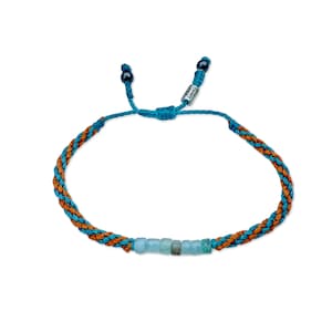 Rumi Sumaq custom Peruvian Opal bracelet shown with two custom fiber colors, blending personalized color choices for a unique unisex style. Designed and hand-knotted by Indigenous Quechua jewelry designer Coco and handmade on Martha’s Vineyard, each bracelet features seven natural Peruvian Opal stones, Hematite accents, and an adjustable drawstring for men, women, or kids. A perfect October birthstone and 24th anniversary gift that celebrates intention, balance, and artisanal craftsmanship.