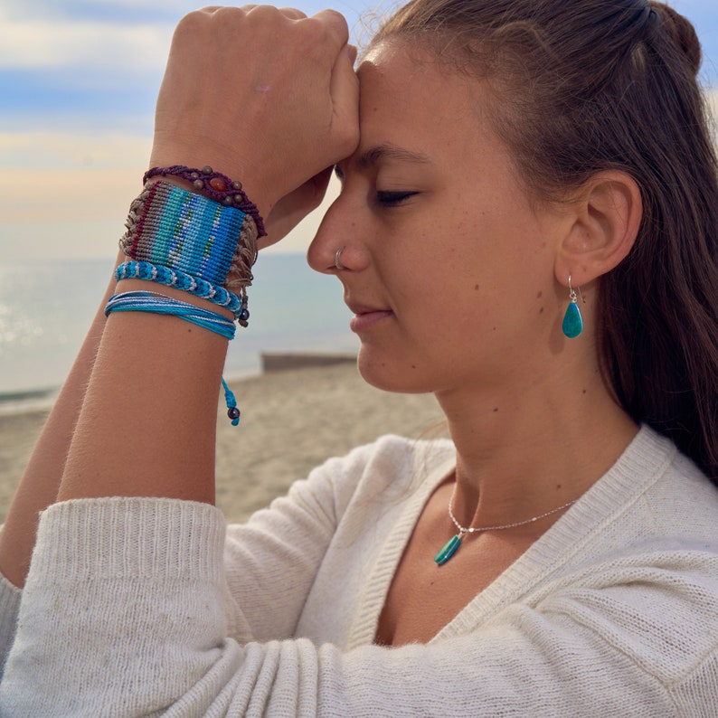 Macrame bracelet in a striped boho design, woven for a unique and colorful festival look. This wide woven bracelet makes a bold statement for women and teen girls. Its intricate knotwork adds an artistic, handmade touch, perfect as hippie jewelry or a bohemian gift for teens. Ideal for everyday wear or festival fashion, this knotted striped bracelet is a must-have for free-spirited styles. Rumi Sumaq jewelry, macrame jewelry for teen girls, unique statement bracelet.