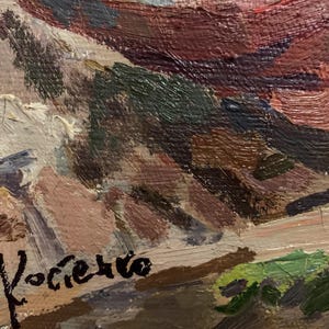 May include: A close-up of a painting with a signature in the bottom right corner that reads "A. Kociciko". The painting features a variety of colors, including brown, red, and green.