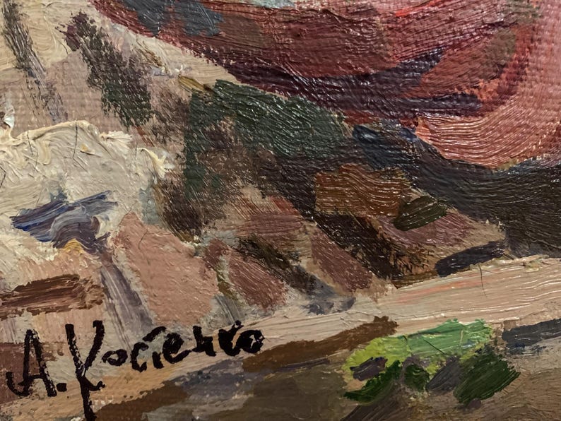 May include: A close-up of a painting with a signature in the bottom right corner that reads "A. Kociciko". The painting features a variety of colors, including brown, red, and green.