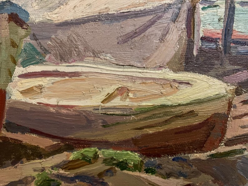 May include: A close-up of a painting depicting a wooden boat with a light brown interior, resting on a rocky shore. The boat is partially obscured by a green bush and a wooden structure in the background.