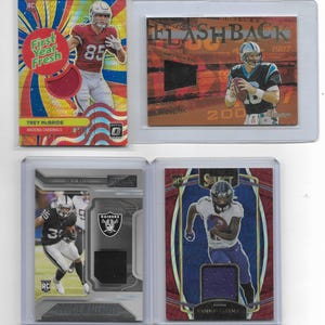 May include: Four football trading cards in protective cases. The cards feature images of players in action, with team logos and player names. One card has the text "First Year Fresh". Another card has the text "Flashback 1987".