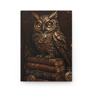 May include: A hardcover journal featuring a mechanical owl with glowing orange eyes and intricate bronze gear details on its feathers. The owl is perched atop a stack of three antique-style leather-bound books, with a small pocket watch visible.