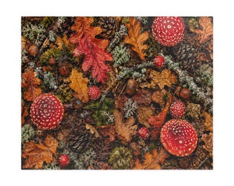 May include: A rectangular jigsaw puzzle featuring a high-angle forest floor scene. The image displays a dense collection of fallen autumn leaves in shades of brown, orange, and red, interspersed with green moss, lichen, pinecones, and red mushrooms.